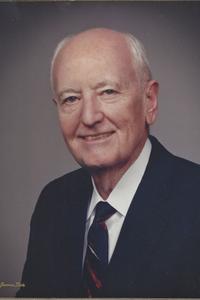 Solo image of Mr. Coulter R. Sublett in his elderly years wearing a suit and smiling